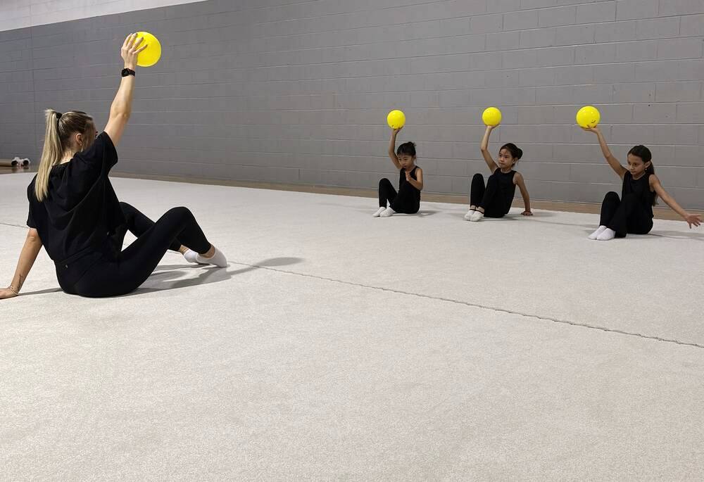 Coach Nastia leading a ball drill with her gymnasts at the Rochester Hills studio